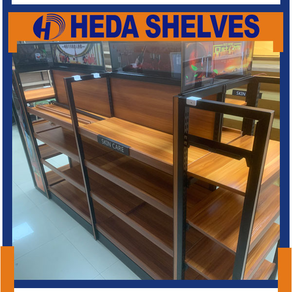 Genuine HEDA WGRFLS01 wooden retail shelving photographed from the opposite side, showing black slotted steel uprights, natural wood shelves, wood-grain back panels and sample SKIN CARE signage