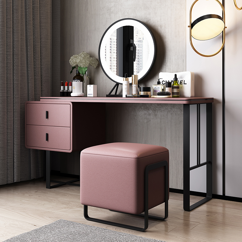 The image shows a modern bedroom setup with a desk, light fixture, and framed picture.