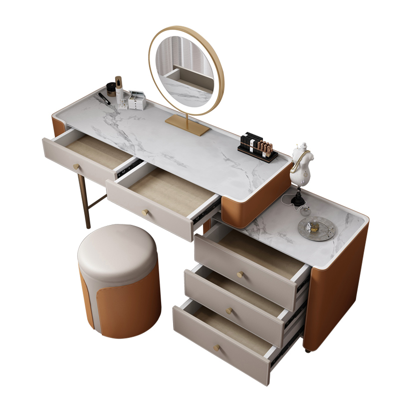 A modern-style desk with drawers and a large mirror above it, with a white marble countertop and personal care items.