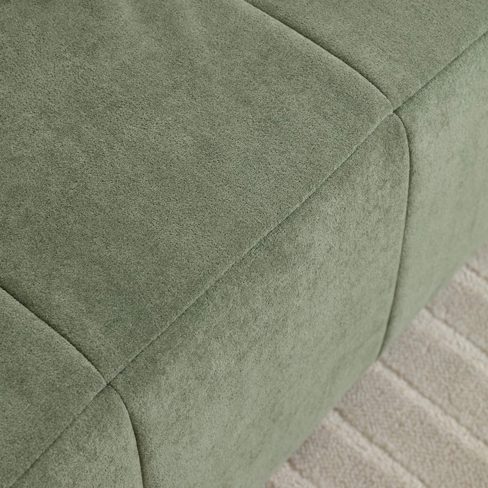 Close-up of the modern green velvet sofa