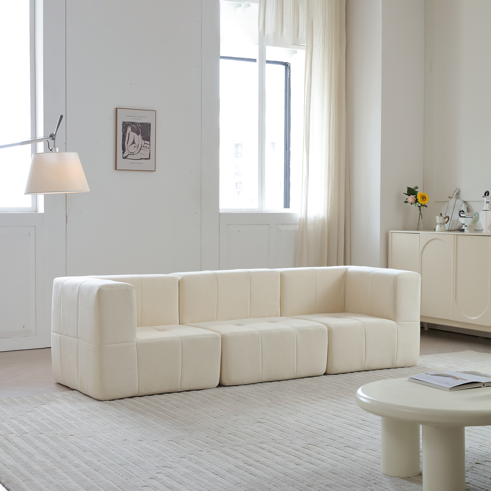 Modern sectional sofa next to window with light curtains