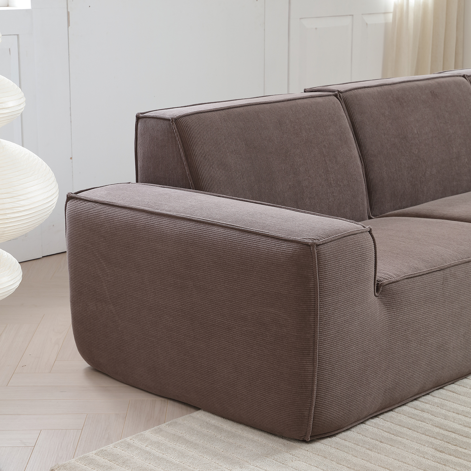 Textured two-seater sofa with ottoman