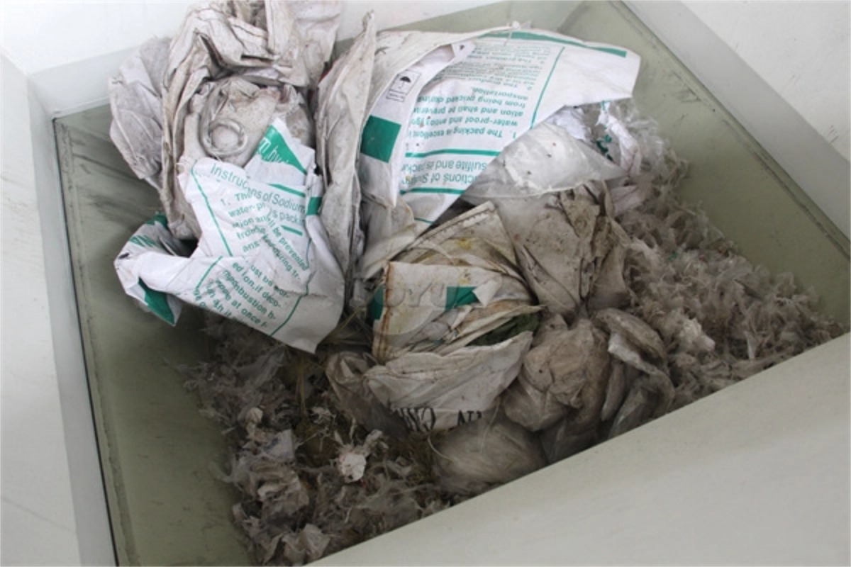 Post-consumer contaminated PP woven bags and giant cement jumbo bags before crushing.