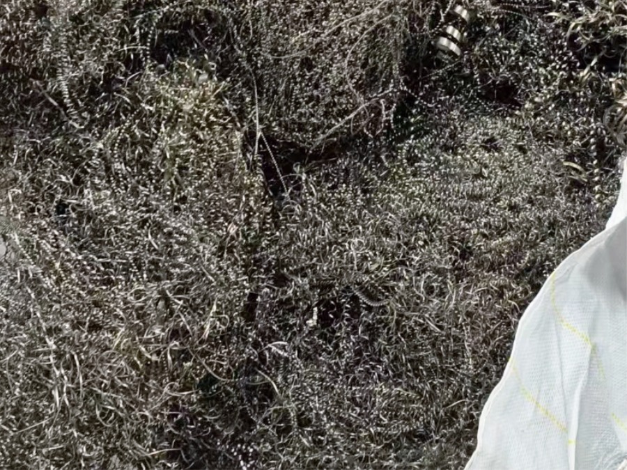 Large pile of dense metal swarf bundles stored in a recycling recycling facility
