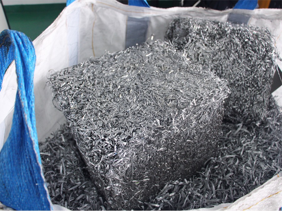 Voluminous loose aluminum turnings and springy aluminum shavings before crushing
