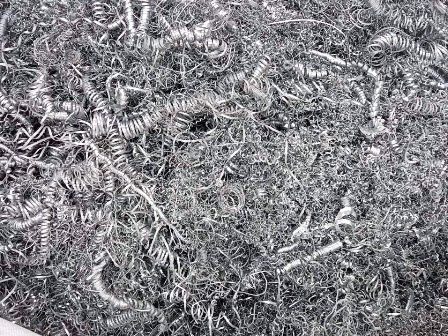 Tangled long steel turnings and loose metal swarf scrap before shredding
