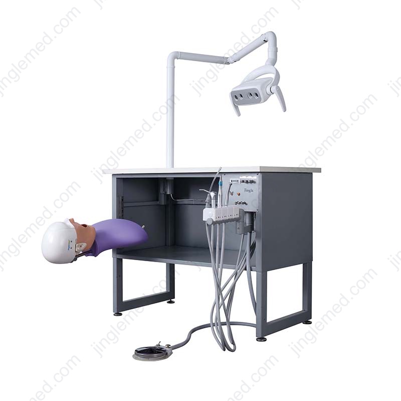 JG-A5+ manual dental simulator with a rail-mounted phantom head and workbench