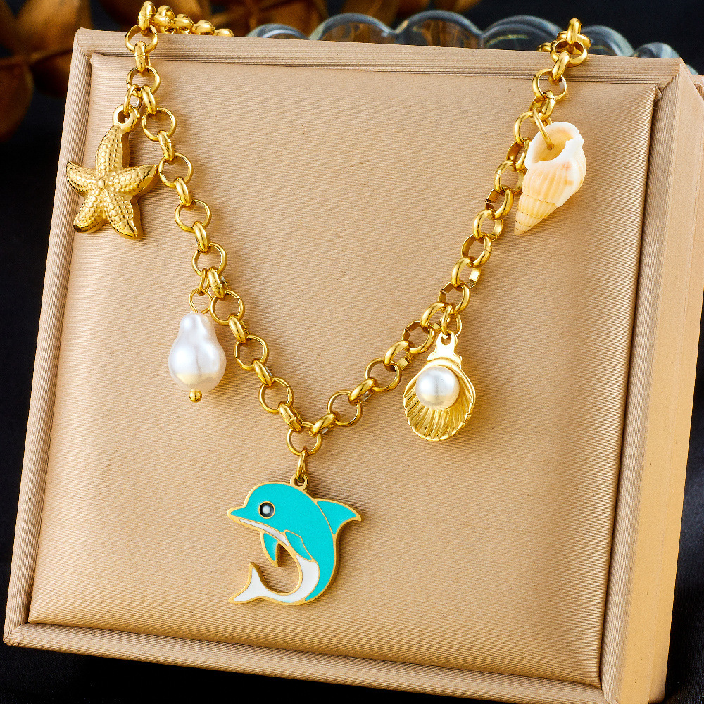 Fashionable and unique resort-style ocean-themed necklace with dripping dolphin, pearl, seashell, and starfish design, featuring a chunky stainless steel chain.