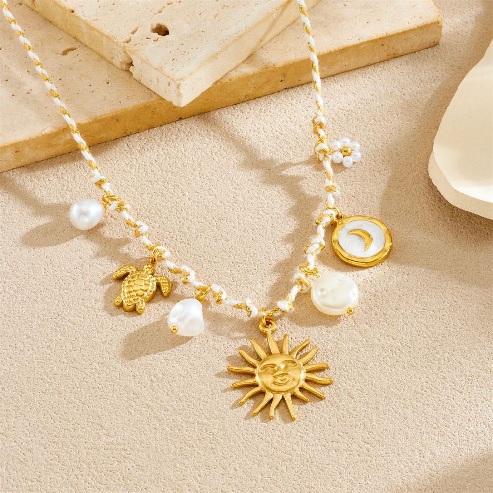 Ocean-themed stainless steel necklace with starfish, turtle, conch, and seashell motifs for women.