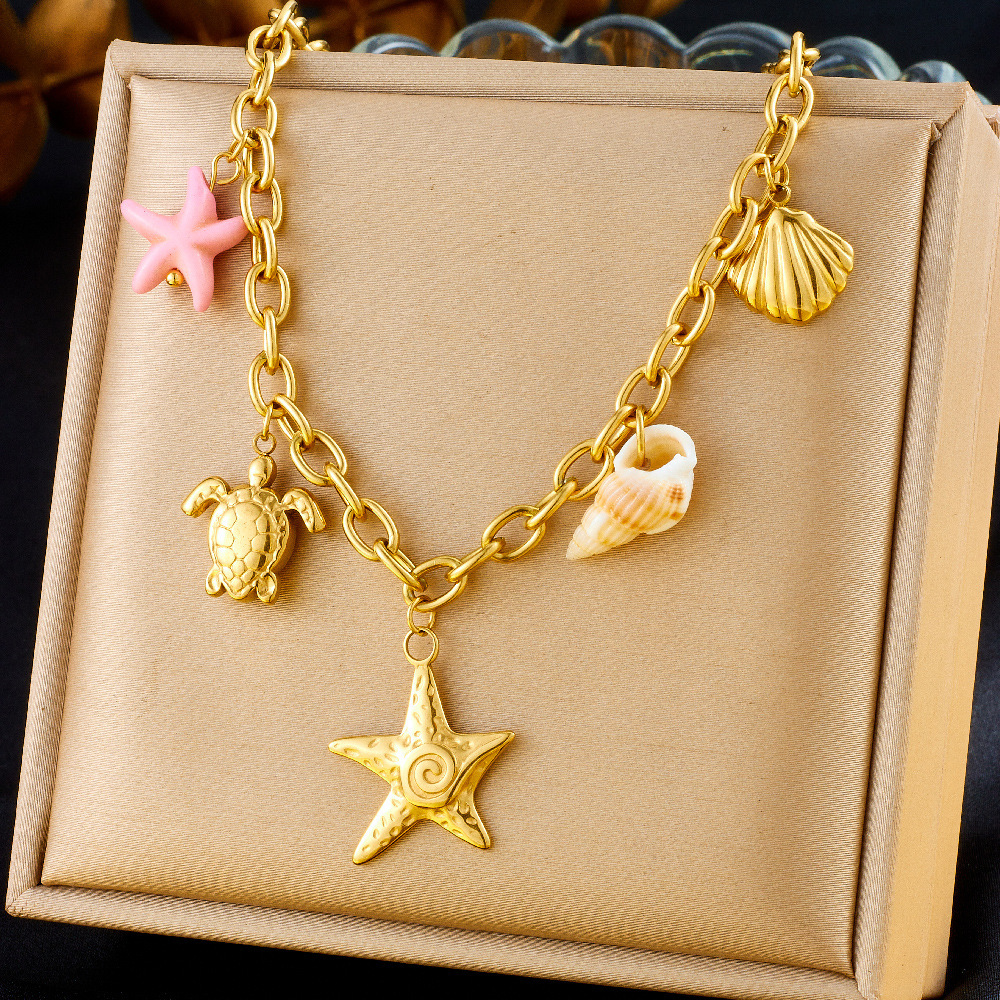 Fashionable and unique resort-style ocean-themed necklace with dripping dolphin, pearl, seashell, and starfish design, featuring a chunky stainless steel chain.