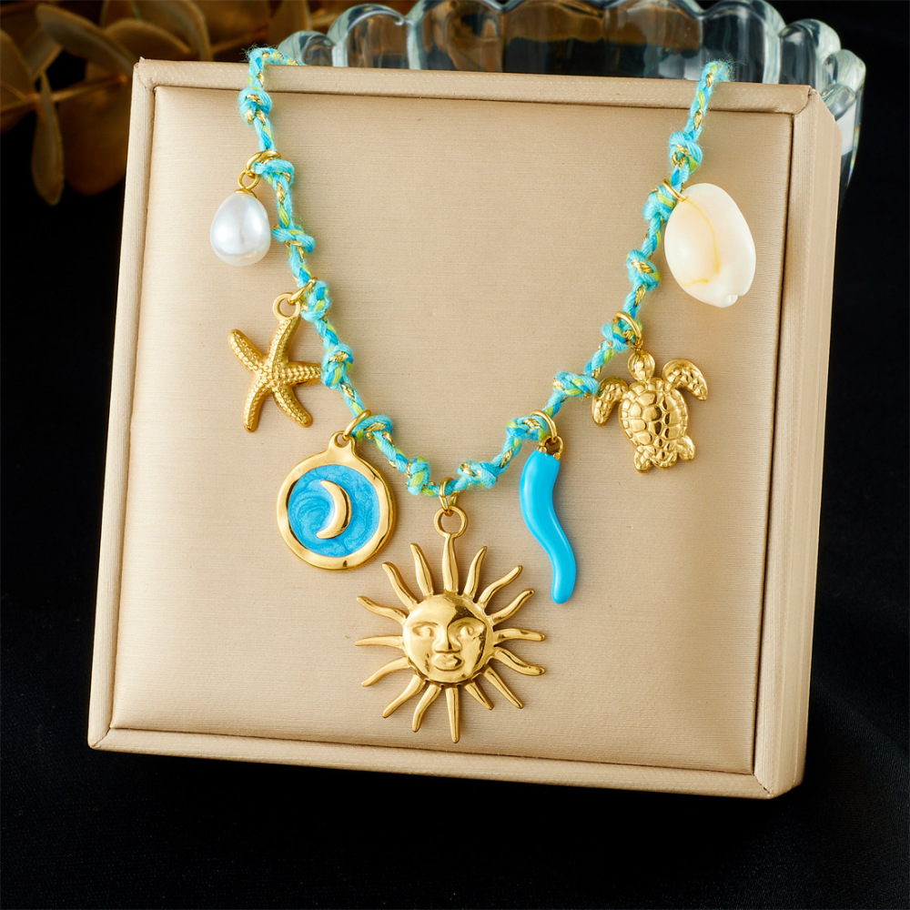 Ocean-themed stainless steel necklace with starfish, turtle, conch, and seashell motifs for women.