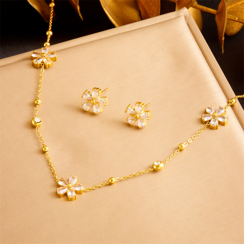 Stylish and simple yet elegant stainless steel jewelry set with transparent rhinestone flower accessories: necklace, earrings, and bracelet (three pieces)