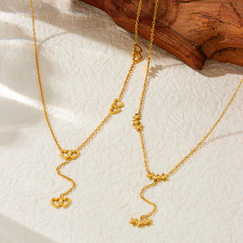 New, unique, versatile, and simple stainless steel necklace with rhinestone-studded heart-shaped accessories and Y-shaped long tassel.