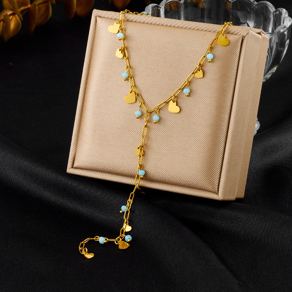 New, unique, versatile, and simple stainless steel necklace with rhinestone-studded heart-shaped accessories and Y-shaped long tassel.