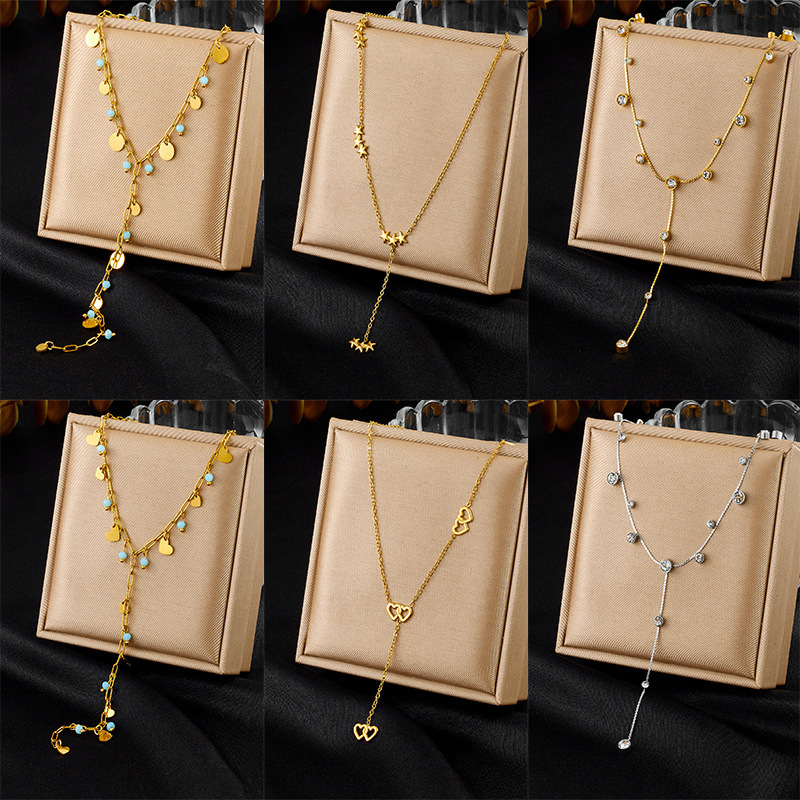 New, unique, versatile, and simple stainless steel necklace with rhinestone-studded heart-shaped accessories and Y-shaped long tassel.