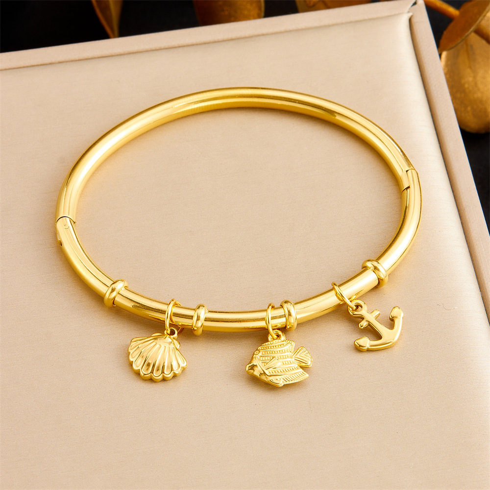 Niche fashion gold-plated stainless steel premium ocean-themed accessories: tropical fish, starfish, butterfly, conch, bamboo bracelet.