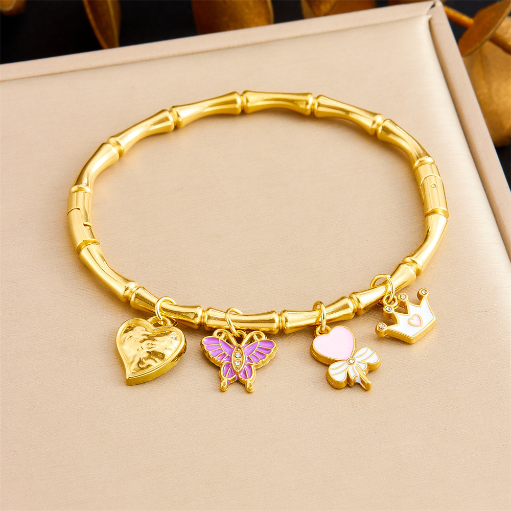 Niche fashion gold-plated stainless steel premium ocean-themed accessories: tropical fish, starfish, butterfly, conch, bamboo bracelet.