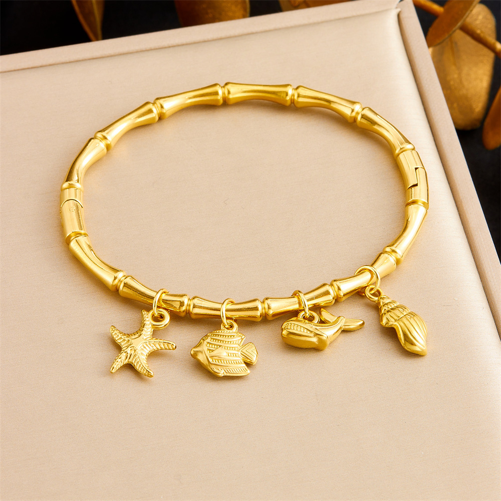 Niche fashion gold-plated stainless steel premium ocean-themed accessories: tropical fish, starfish, butterfly, conch, bamboo bracelet.