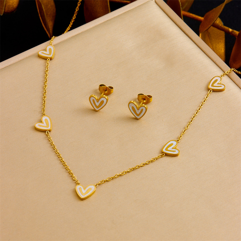 Stylish and exquisite white shell heart accessory clavicle chain, stainless steel stud earrings, necklace, and bracelet – a versatile women's set.