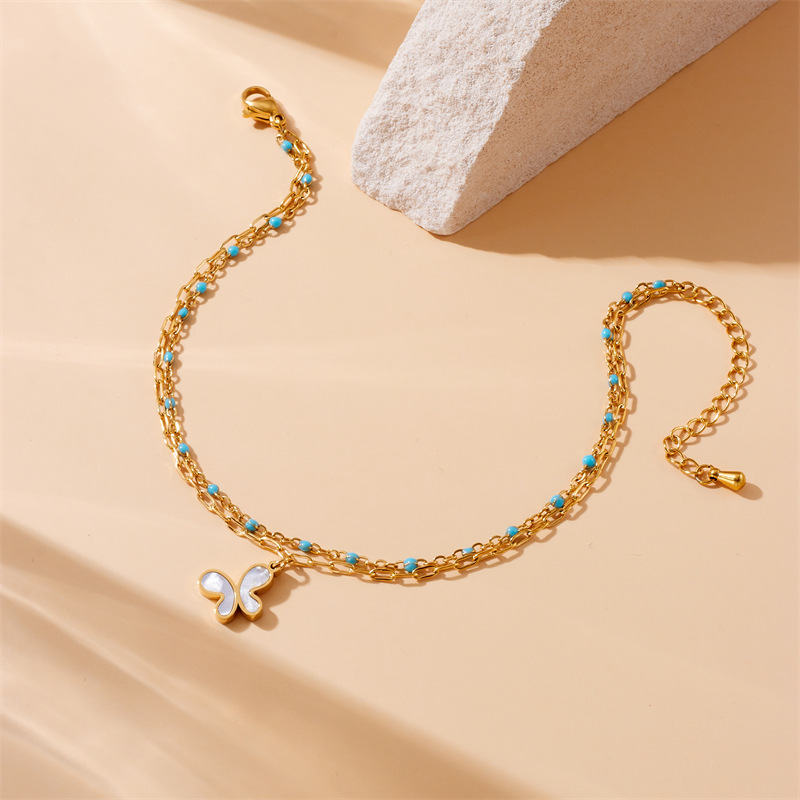 Fashionable, retro, simple, versatile, double-layered, turquoise, gold-plated chain, stainless steel butterfly and flower pendant anklet.