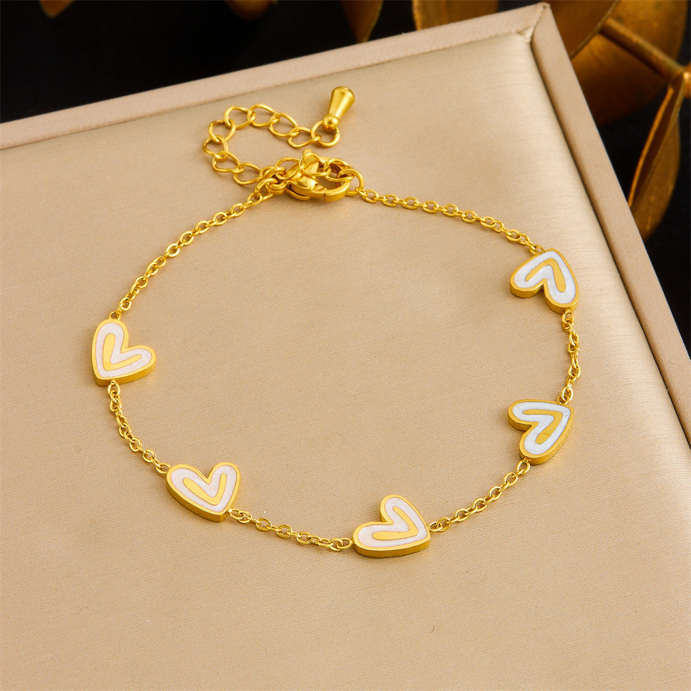 Stylish and exquisite white shell heart accessory clavicle chain, stainless steel stud earrings, necklace, and bracelet – a versatile women's set.