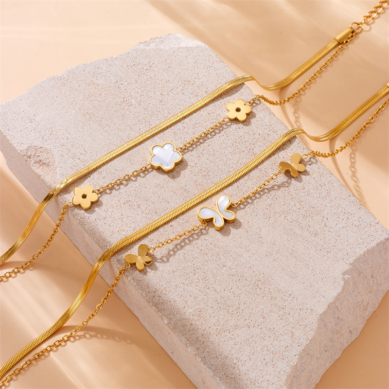 Stylish, niche, minimalist, elegant white seashell, butterfly, and flower accessory chain; multi-layered stainless steel anklet.