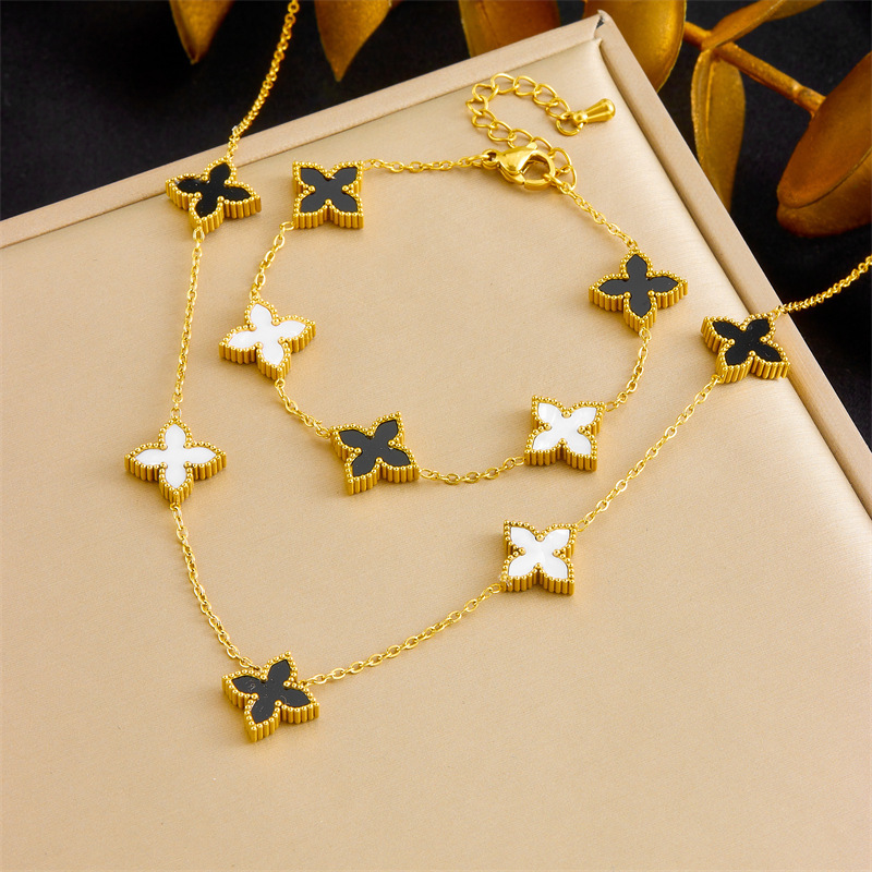 Korean style light luxury black and white double-sided reversible four-leaf clover necklace, simple and unique bracelet, fashionable and versatile jewelry set.
