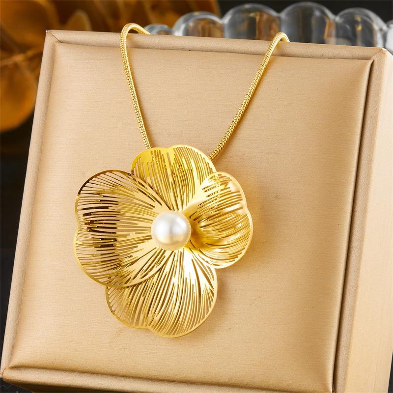 Stylish and elegant pearl necklace, earrings, and ring set featuring openwork petals and a pearl design.