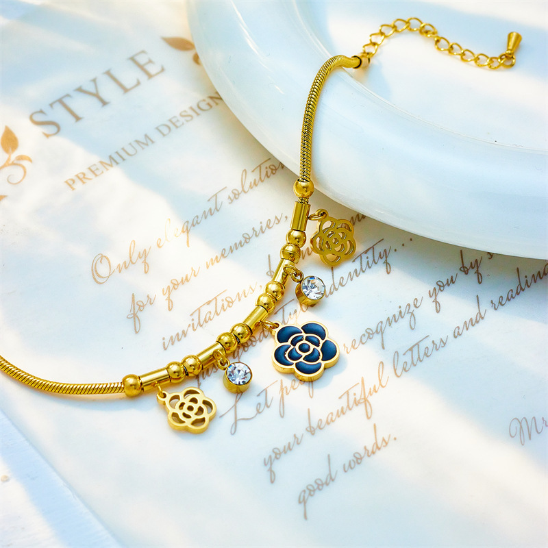 Niche design, stylish and minimalist French retro style, hollowed-out camellia pendant with diamond setting, titanium steel chain.