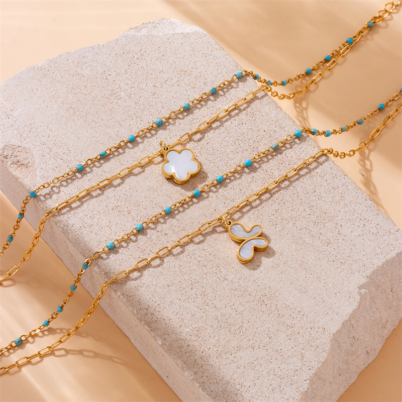 Fashionable, retro, simple, versatile, double-layered, turquoise, gold-plated chain, stainless steel butterfly and flower pendant anklet.