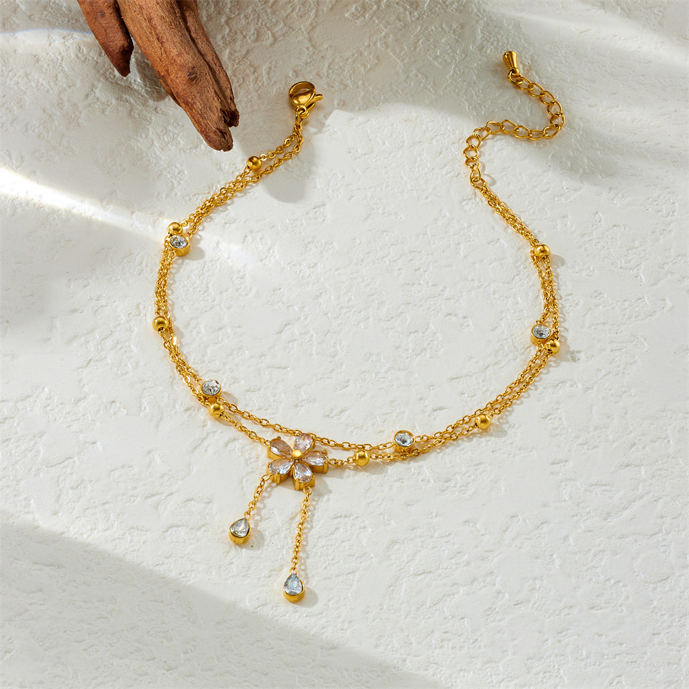 New fashionable diamond-encrusted five-petal flower chain with tassels, double-layered stainless steel gold-plated delicate chain anklet.