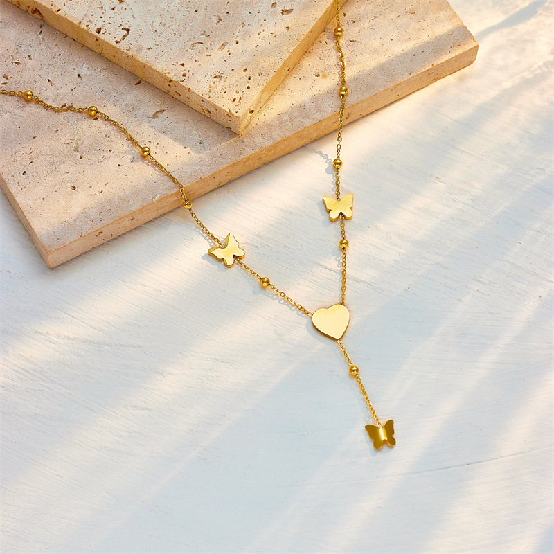 Japanese and Korean style, simple and versatile, elegant and luxurious heart-shaped butterfly tassel pendant, titanium steel metal jewelry necklace.