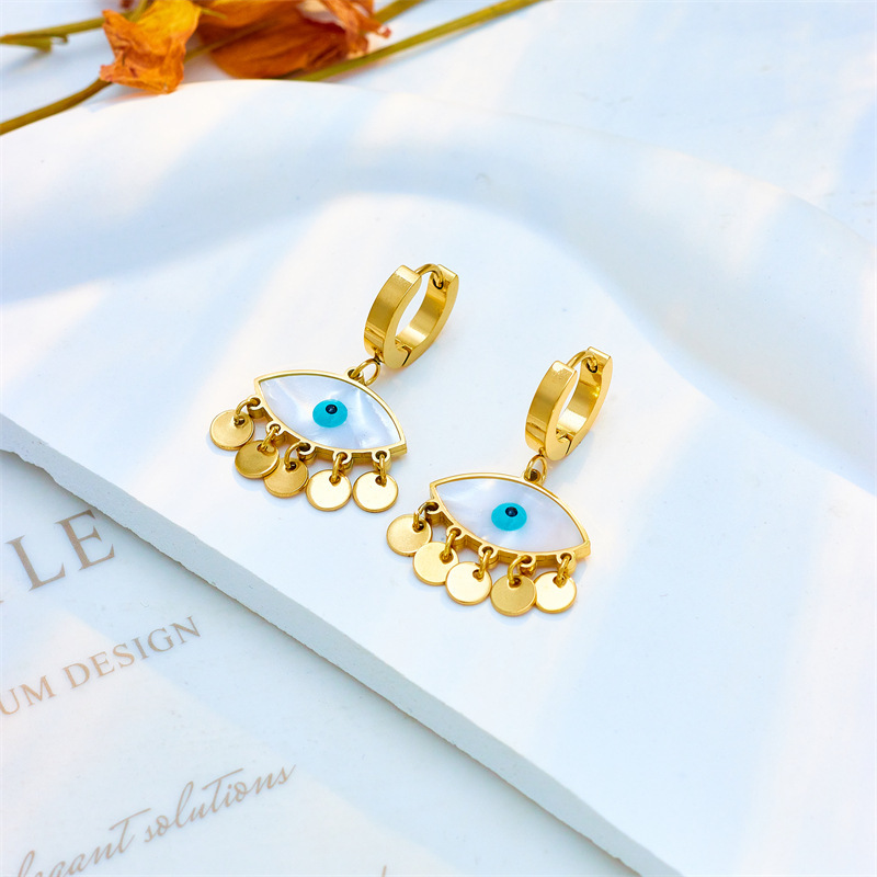 European and American cross-border personalized fashion creative niche oval blue eye earrings with round tassels titanium steel jewelry ear hoops