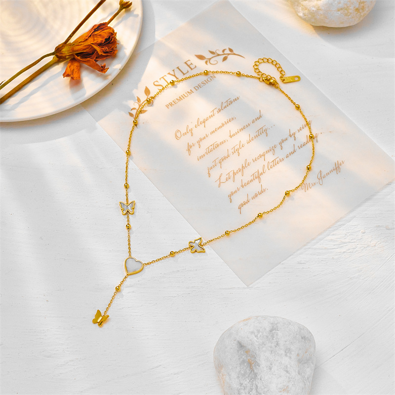 Japanese and Korean style, simple and versatile, elegant and luxurious heart-shaped butterfly tassel pendant, titanium steel metal jewelry necklace.