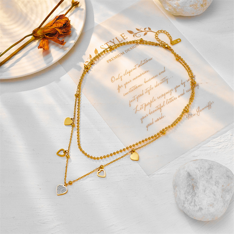 Fashionable double-layer titanium steel heart-shaped beaded necklace with diamond embellishments, a unique design.