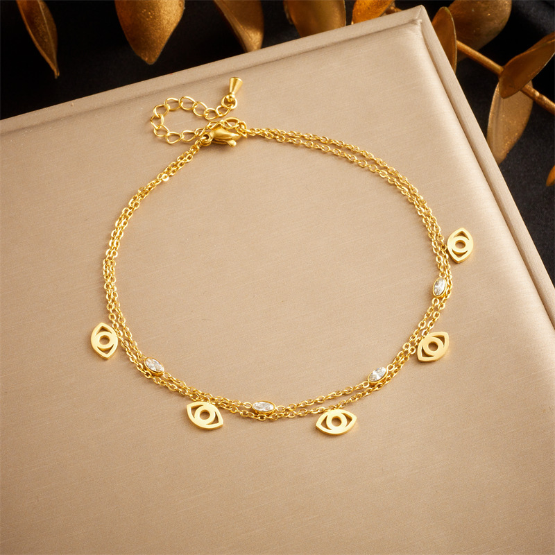 European and American style niche personalized double-layered stainless steel anklet with small flower eyes, teardrop design, rhinestone tassels.