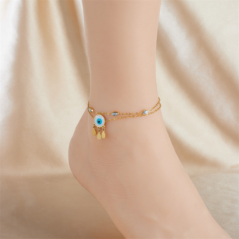 European and American style niche personalized double-layered stainless steel anklet with small flower eyes, teardrop design, rhinestone tassels.