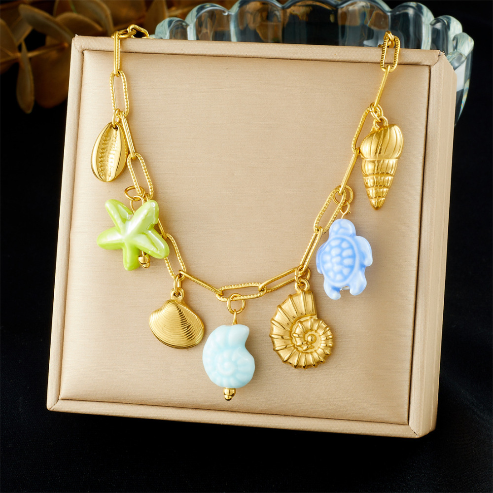 Korean-style fashionable beach vacation style, gold-plated cross chain, seashell pendant, acrylic starfish and turtle necklace.