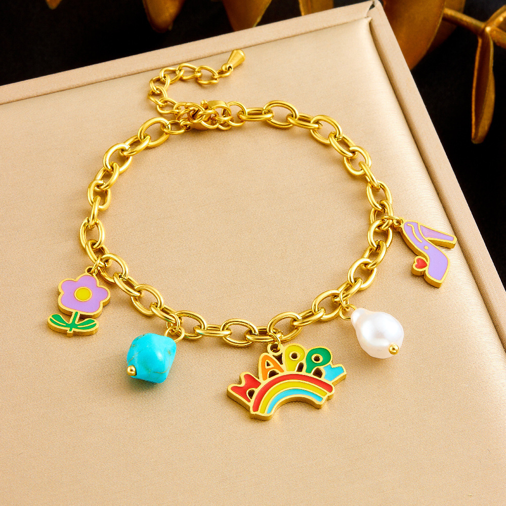 A unique and trendy cute cartoon-style jewelry set featuring a rainbow pendant with turquoise flowers and mixed elements.
