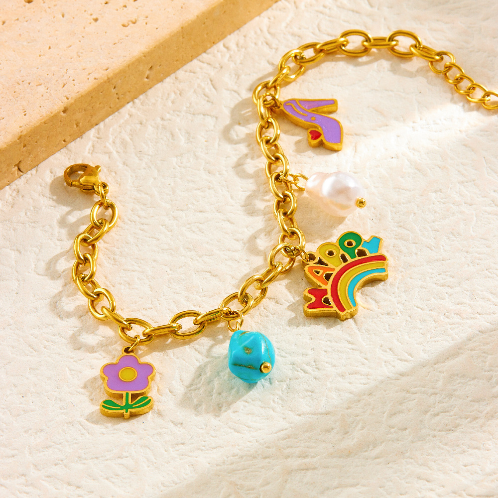 A unique and trendy cute cartoon-style jewelry set featuring a rainbow pendant with turquoise flowers and mixed elements.