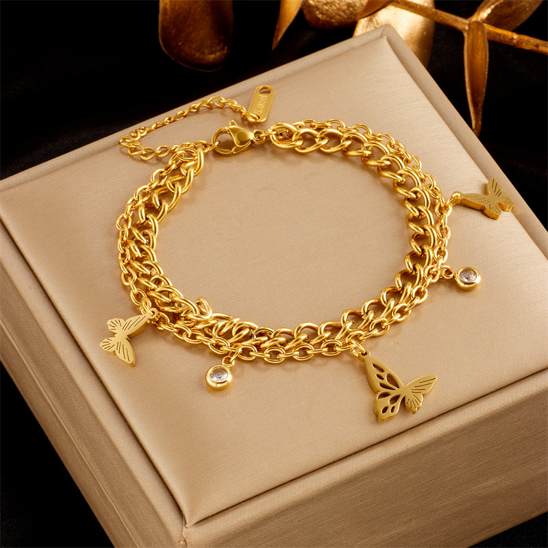Stylish, sophisticated, niche design, understated luxury, versatile gold-plated butterfly, pearl, flower, and diamond-encrusted bracelet.
