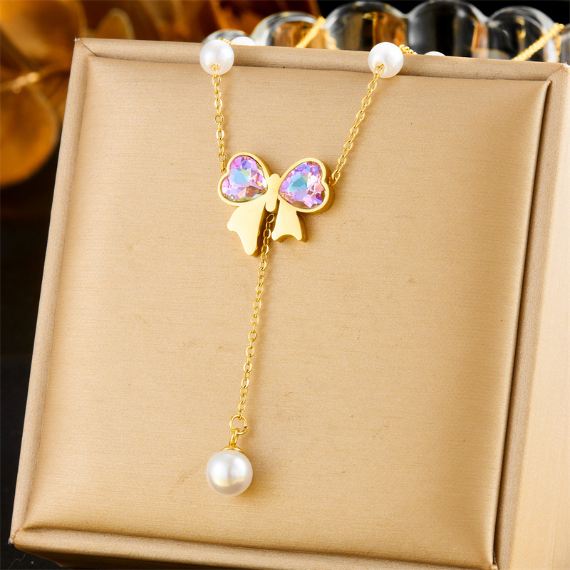Cross-border fashion dazzling rhinestone bow gold-plated pearl chain stainless steel tassel pendant necklace and bracelet set