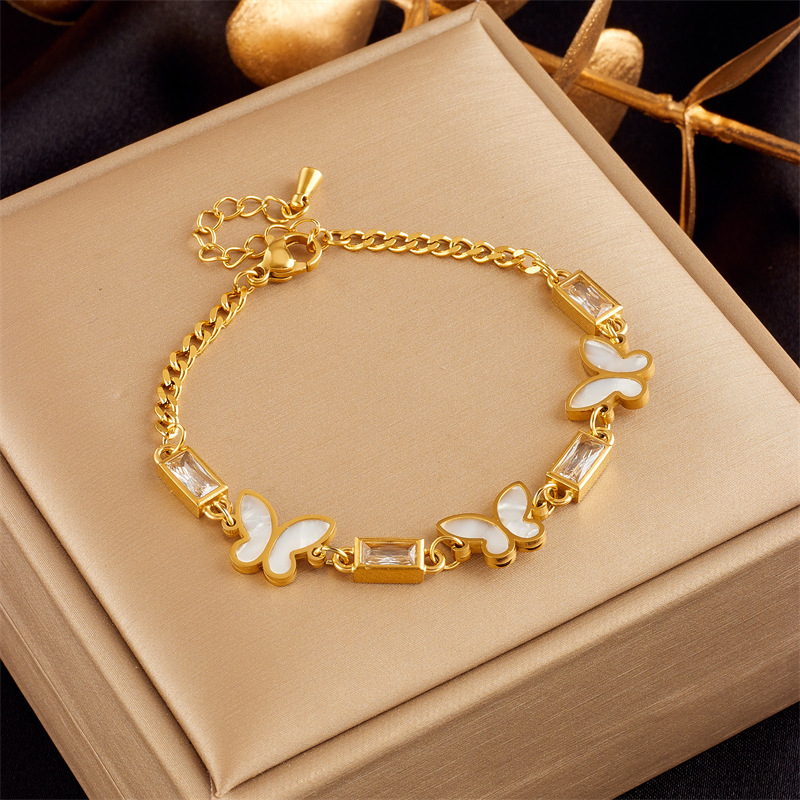 Stylish, sophisticated, niche design, understated luxury, versatile gold-plated butterfly, pearl, flower, and diamond-encrusted bracelet.
