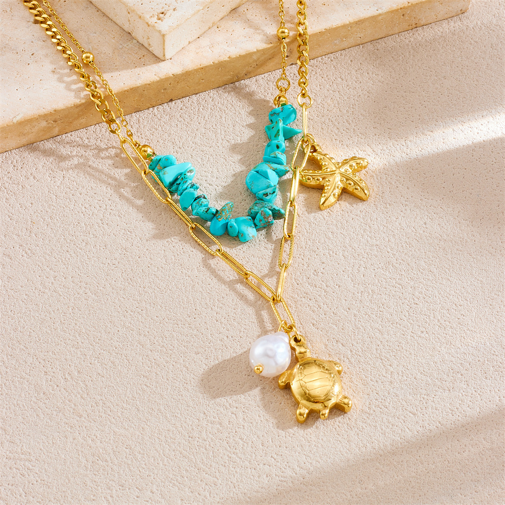 Fashionable and trendy double-layered stainless steel chain necklace featuring a turtle, starfish, blue pebble, and pearl design.