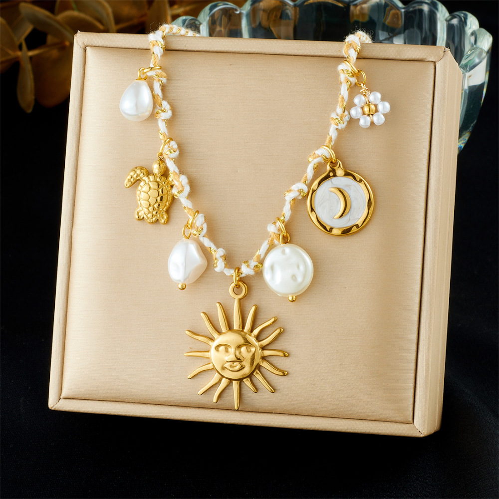 Ocean-themed stainless steel necklace with starfish, turtle, conch, and seashell motifs for women.