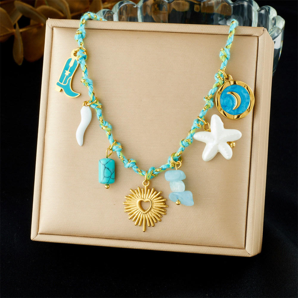 Ocean-themed stainless steel necklace with starfish, turtle, conch, and seashell motifs for women.