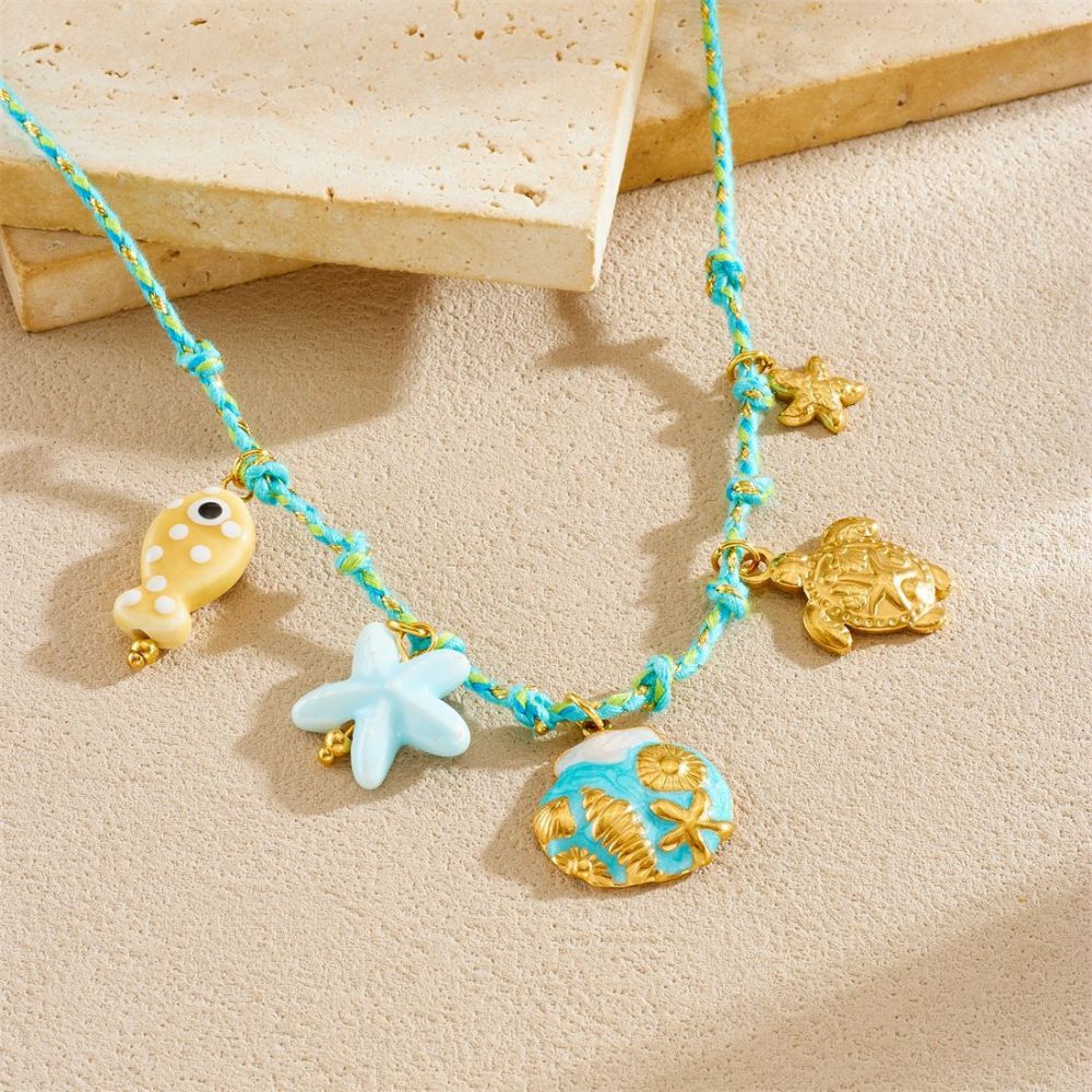 Ocean-themed stainless steel necklace with starfish, turtle, conch, and seashell motifs for women.