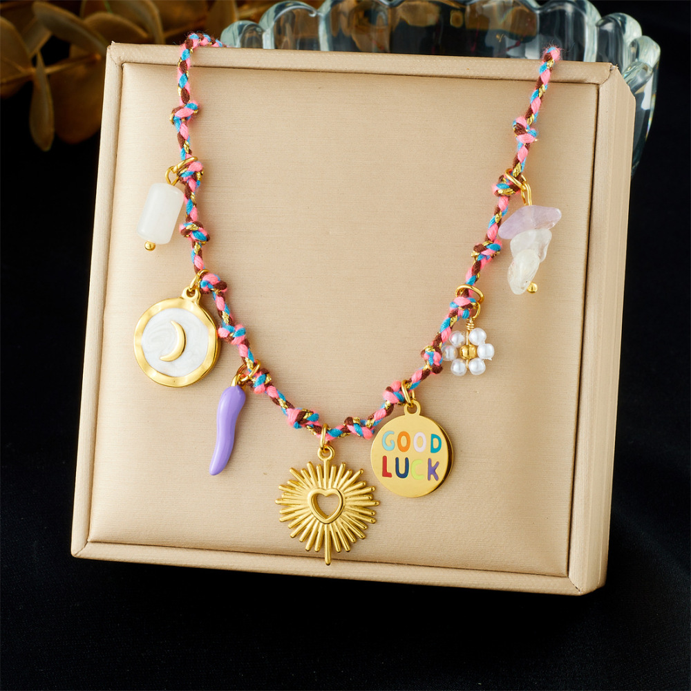 Ocean-themed stainless steel necklace with starfish, turtle, conch, and seashell motifs for women.