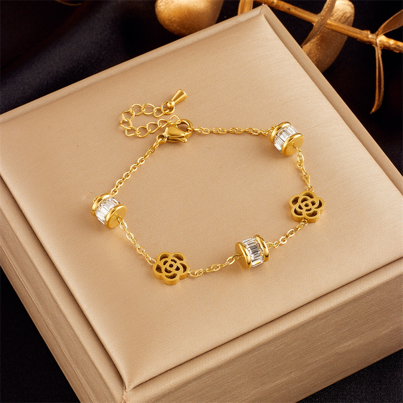 Stylish, sophisticated, niche design, understated luxury, versatile gold-plated butterfly, pearl, flower, and diamond-encrusted bracelet.