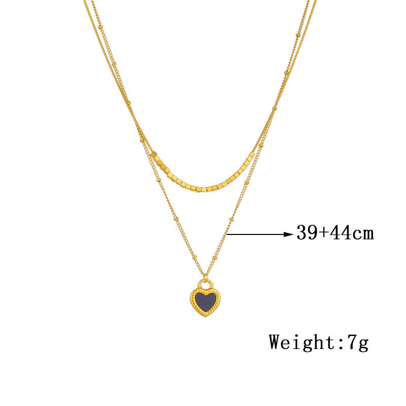 European and American style, simple and versatile, heart-shaped gold-plated titanium steel double-layer chain necklace with black and white heart pendant.
